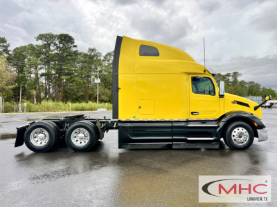 Peterbilt 579 truck side view in yellow sleeper cab with 6x4 chassis