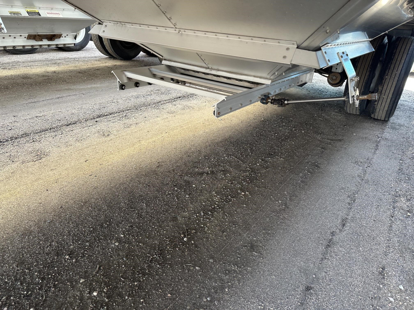 Grain trailer undercarriage showing 74" side clearance and air ride suspension with lower access ladder and underside frame.