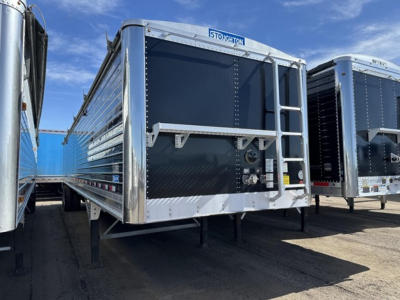 Stoughton grain trailer hopper showing rear access ladder and tagging with Stoughton logo.