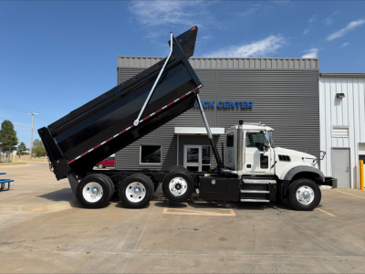 Truck in-service Mack GR84F dump truck with raised bed showing side profile and VIN/stock context.