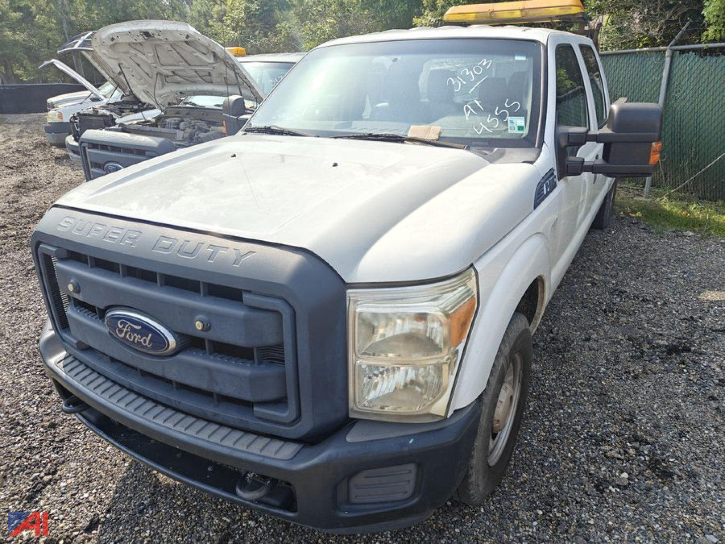 Ford F-250 Super Duty front-left view showing crew cab pickup with open hood and utility lights on roof.