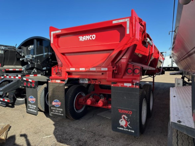Ranco rock end dump trailer showing red hopper with RANCO branding and dual rear axles with black mud flaps.
