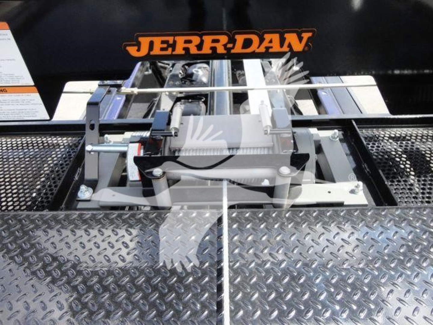 Ram 5500 rollback equipment mounted on diamond plate bed with Jerr-Dan branding visible