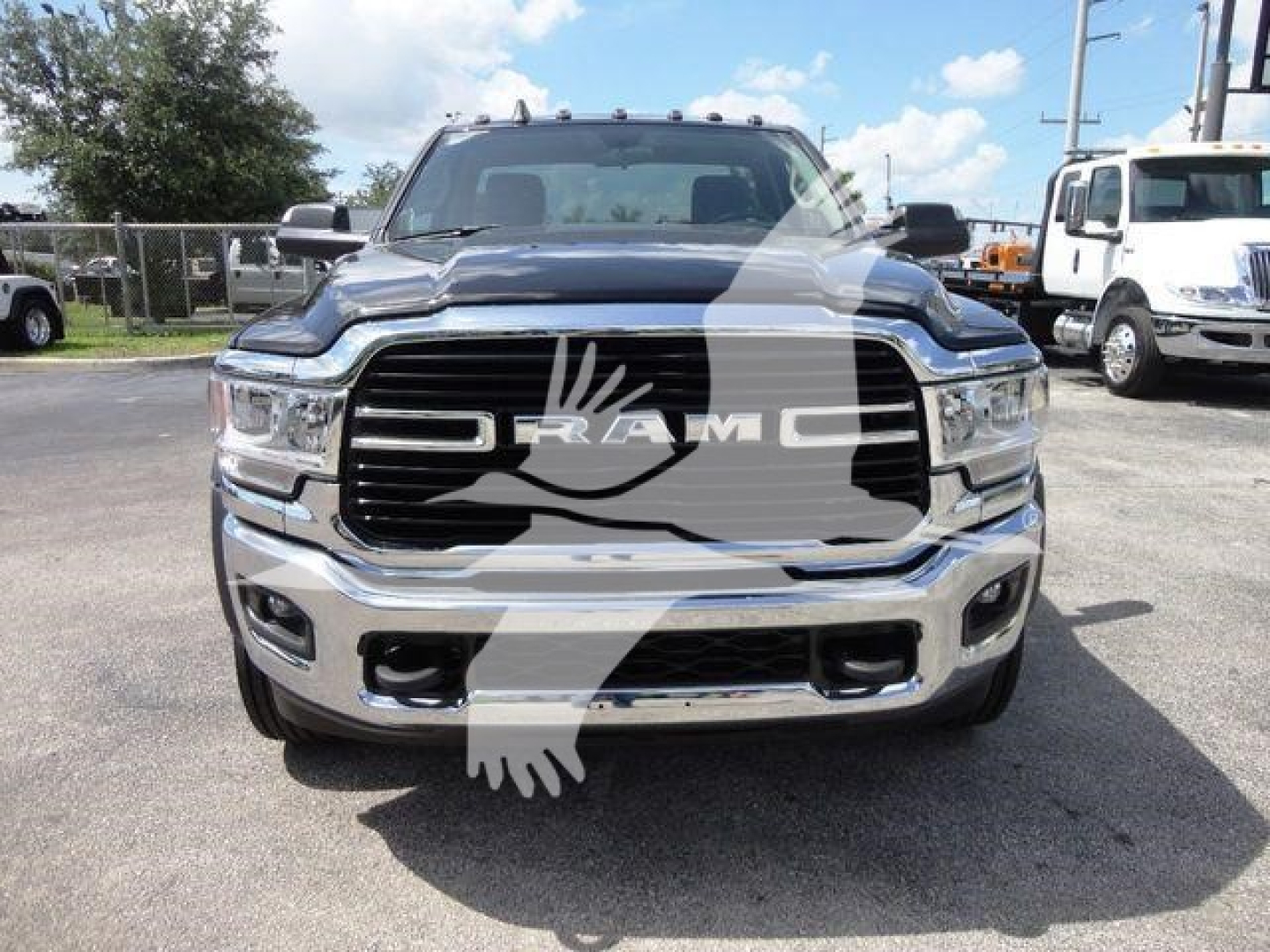 Ram 5500 front view showing grille with RAM badge and chrome bumper, HD truck in silver with black accents.