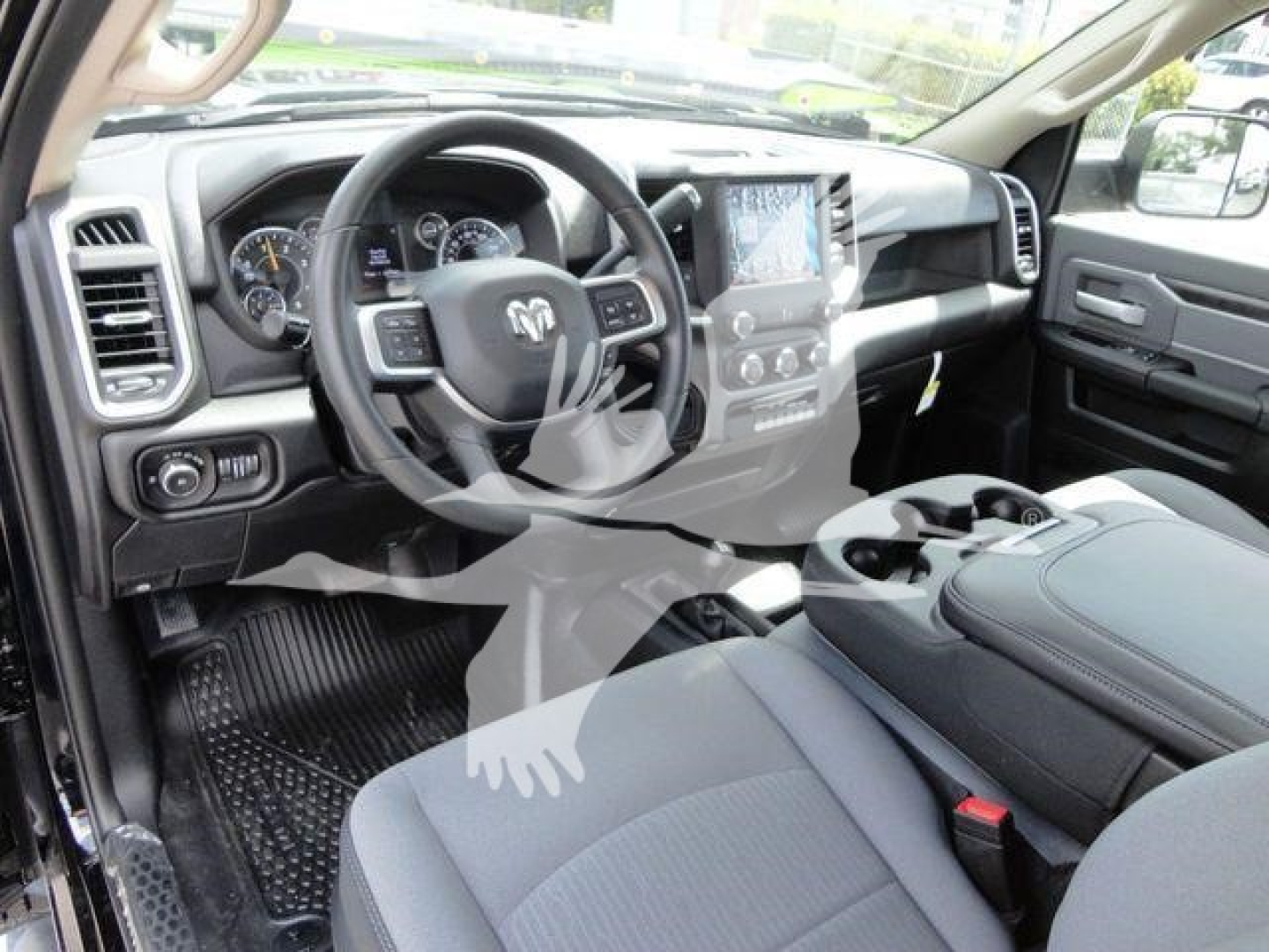 Ram 5500 interior showing steering wheel with RAM logo, center touchscreen, and front seats; dashboard and console visible