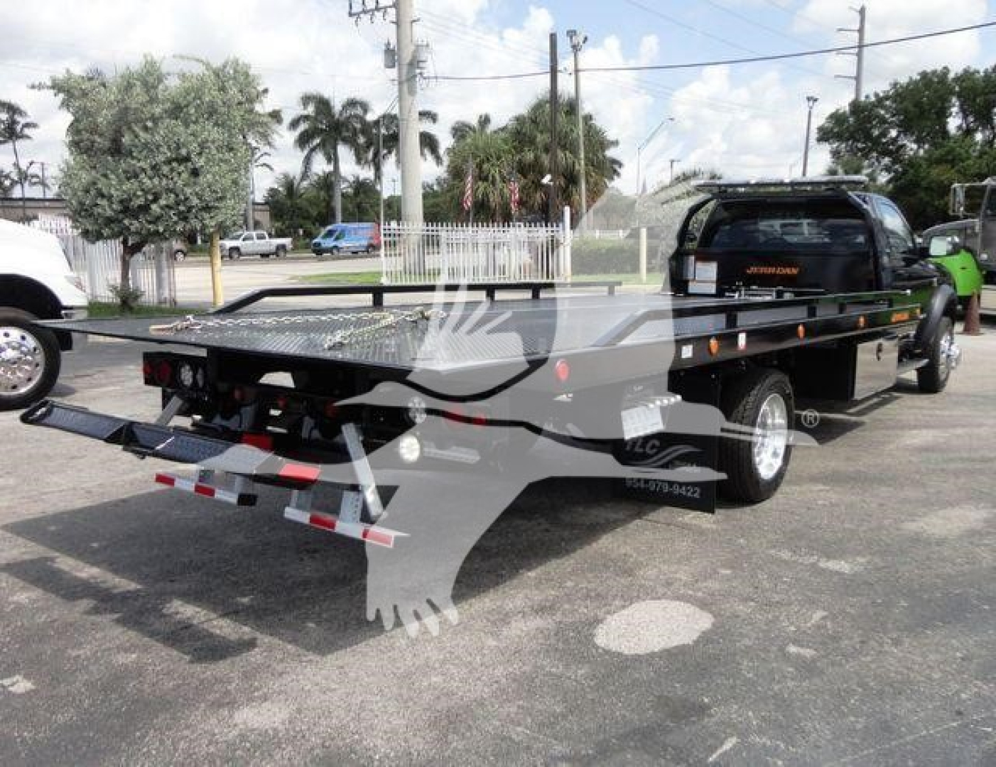 Ram 5500 SLT rollback truck with flatbed trailer showing rear and side view, stock number J67261.