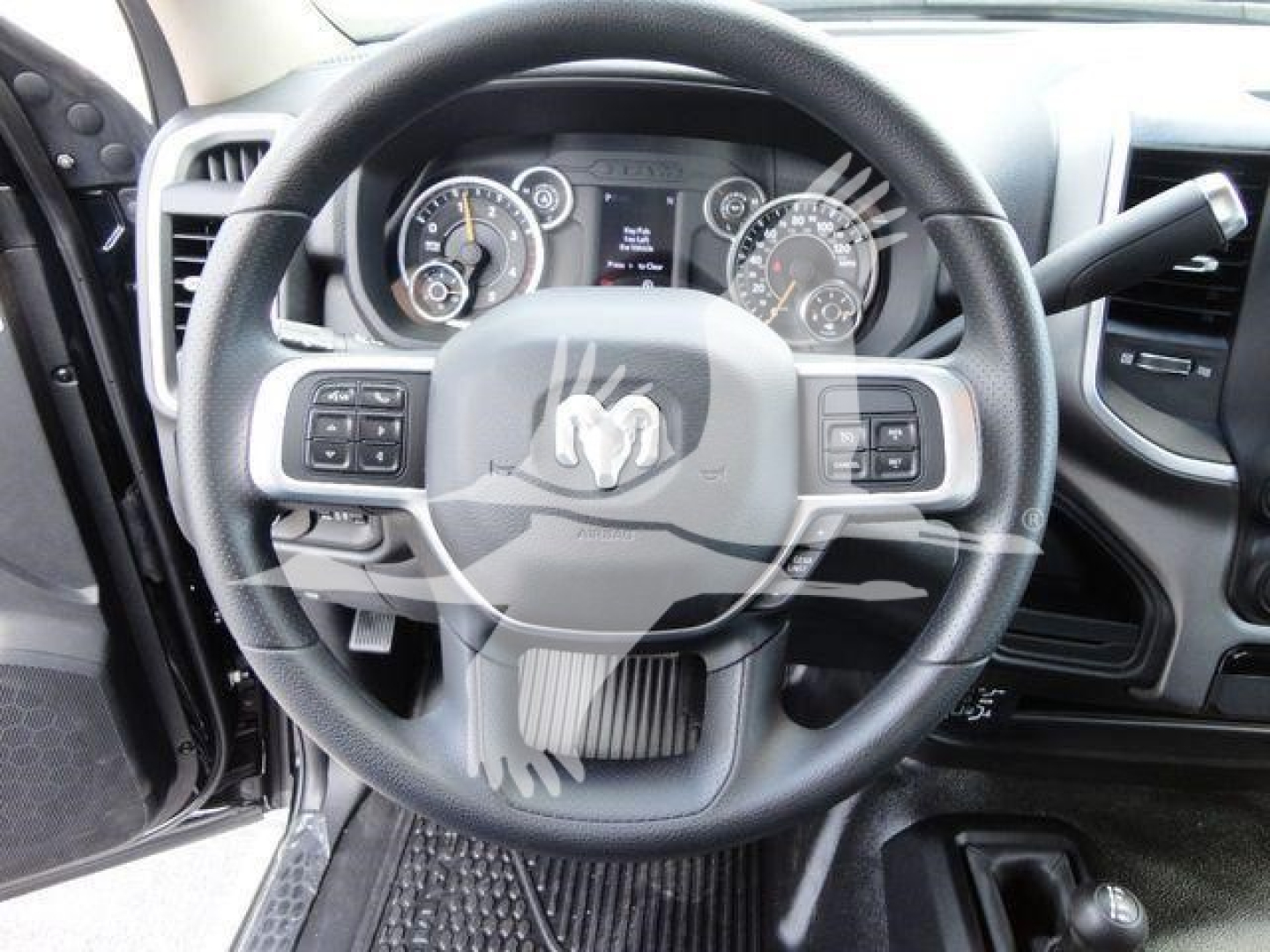 Ram steering wheel and dashboard with instrument cluster in view; no visible text legible besides generic gauge markings.