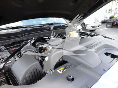 Ram 5500 engine bay with hood open showing air intake and engine cover text near center of image.