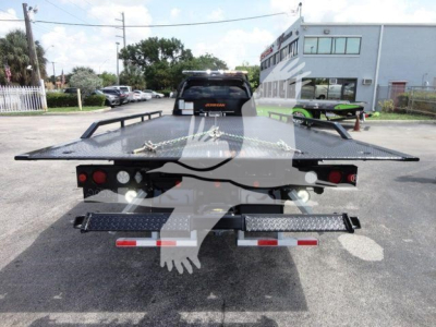Ram 5500 rollback bed from rear showing flatbed with dual rear lights and bumper steps.