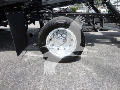 Ram 5500 rollback truck wheel and suspension view showing single rear axle and chrome wheel.