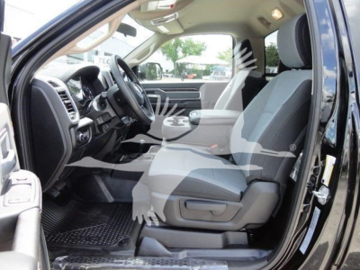Ram 5500 SLT truck interior driver side view showing front seat and dashboard with light-gray seats.
