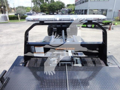 Truck bed with a gooseneck hitch and metal diamond plate, light bar on top, Ram brand branding visible on the hitch frame.