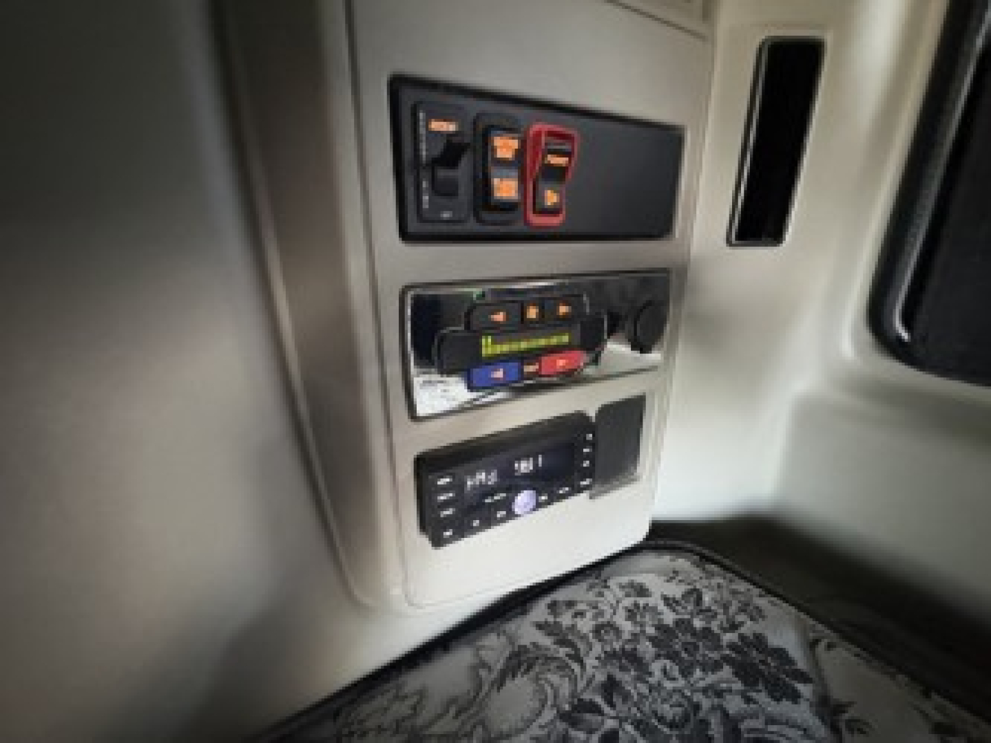 Truck interior panel with switches and control modules visible