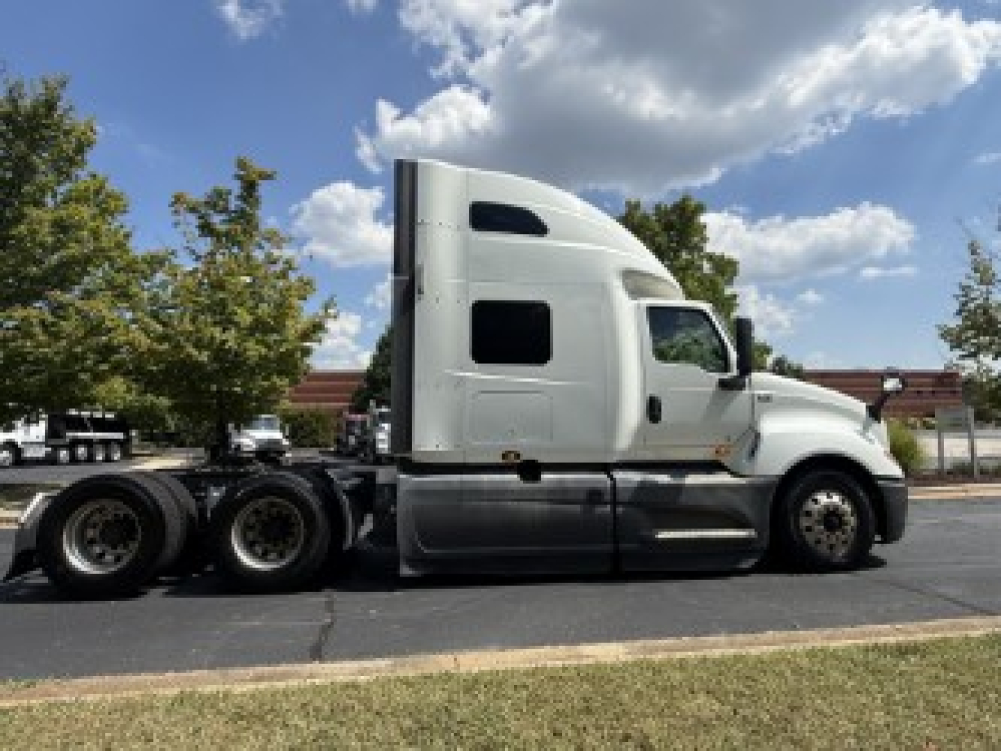 International LT625 tractor in profile view showing sleeper cab and attached trailer/tractor wheels.