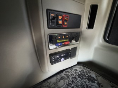 Truck interior panel with switches and control modules visible