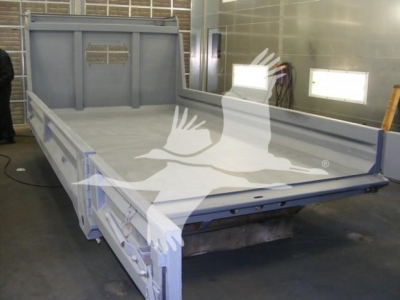 Dump truck flatbed trailer bed of a 2026 Advanced Fabricators 14 ft yard trailer showing flat gray deck and side rails.