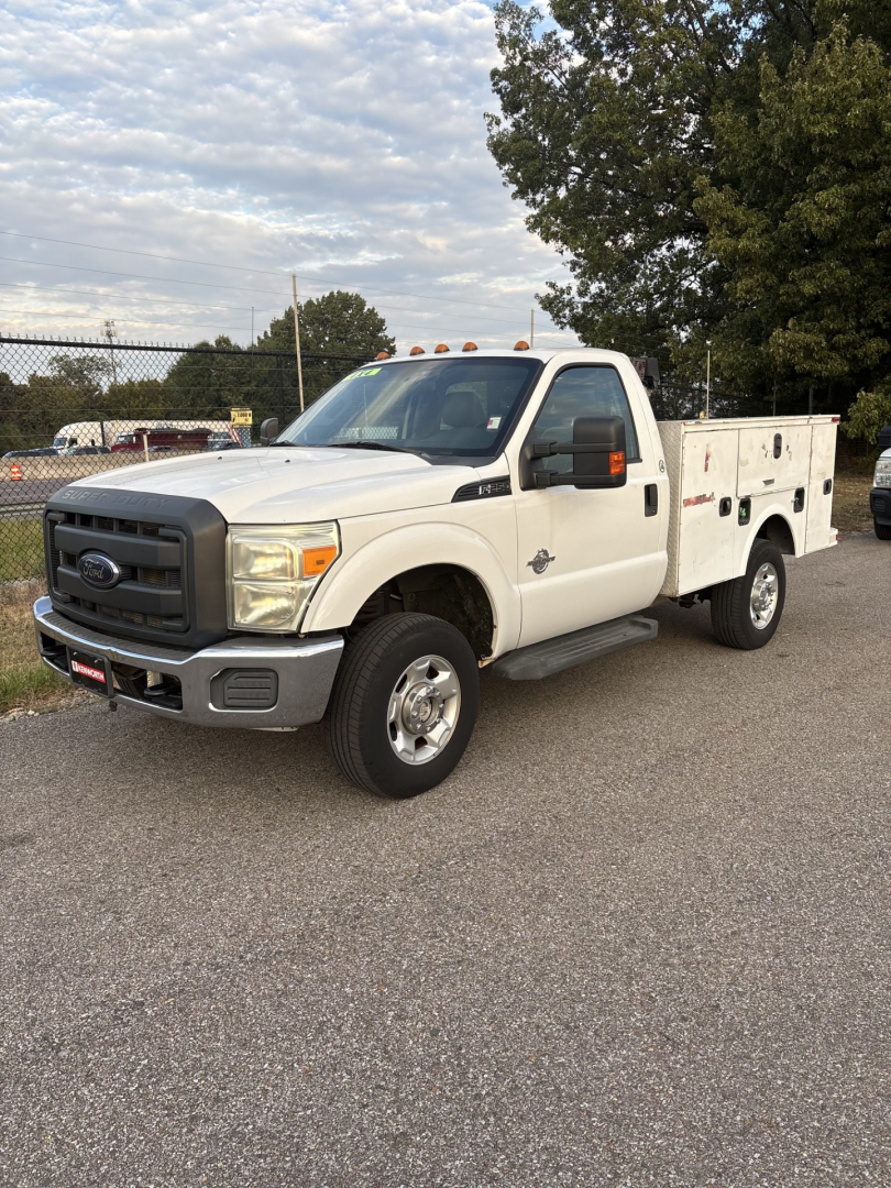 Ford F-250 utility service truck white cab with utility bed, front view at angle.