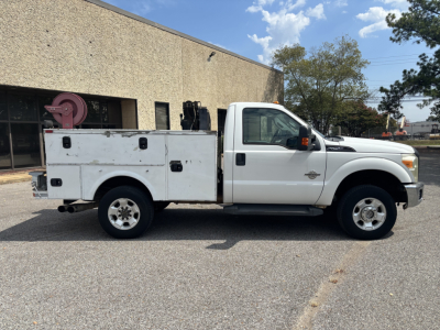 Service/Utility white 2012 Ford F-250 utility body truck side view showing service/storage compartments and dual rear wheels.