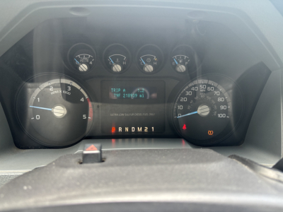 Ford instrument cluster showing tachometer, speedometer, and digital trip readout in a 2012 Ford F-250 dash.