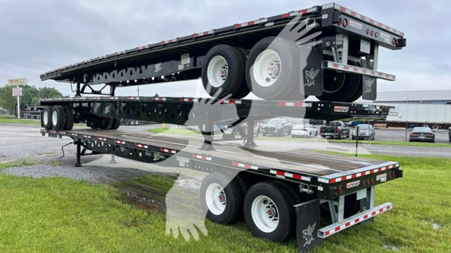Manac steel flatbed trailer with S/R slider in stacked layout showing flatbed and wheels