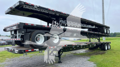 Manac steel flatbed trailer with S/R slider in extended position on a dual-axle trailer.