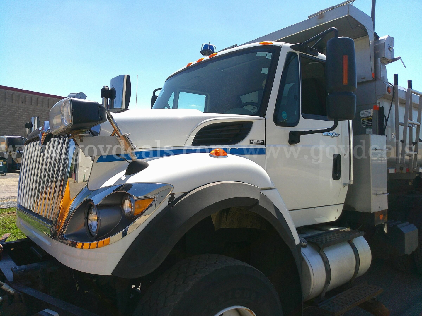 International truck cab in-service showing front grille and plow equipment with bumper lights.