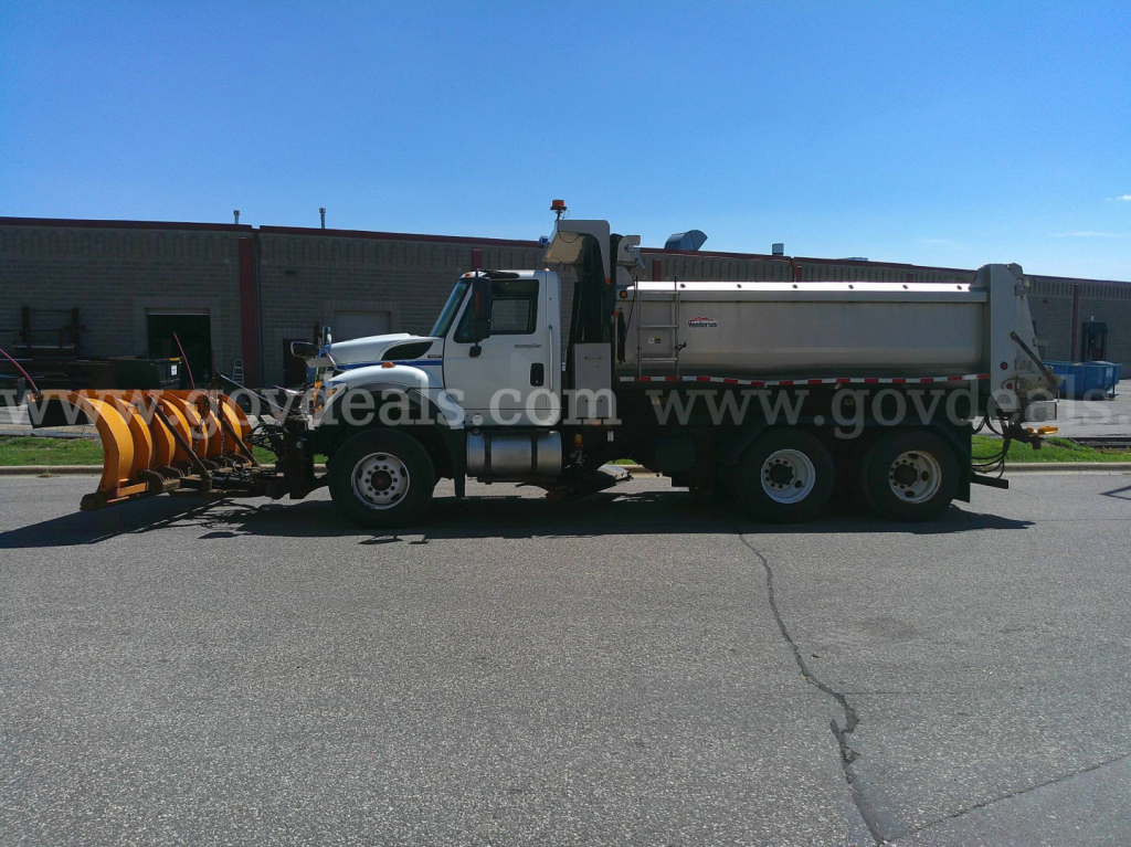 Truck with plow and dump body side view showing International 7600 chassis.