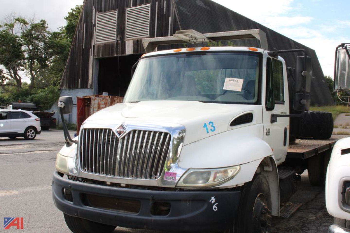International truck in flatbed configuration showing front grille with number 13 on fender and side markers.