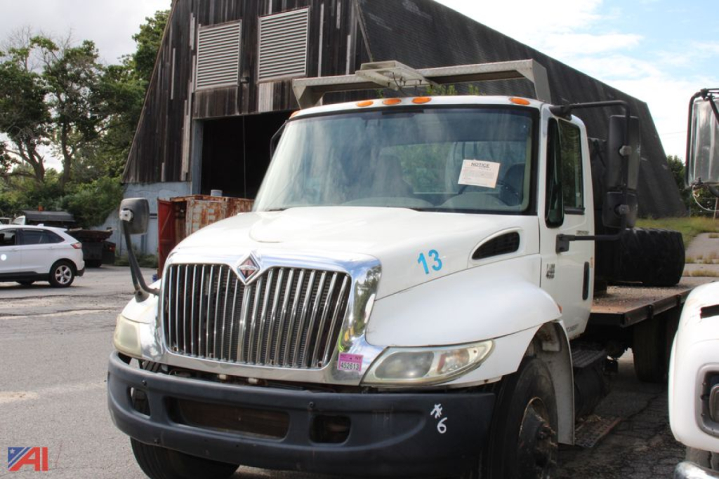 International truck in flatbed configuration showing front grille with number 13 on fender and side markers.