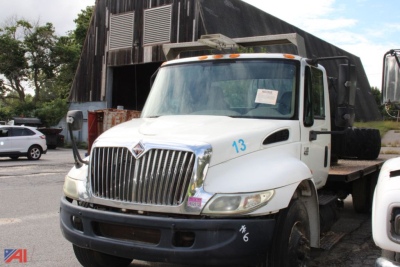 International truck in flatbed configuration showing front grille with number 13 on fender and side markers.