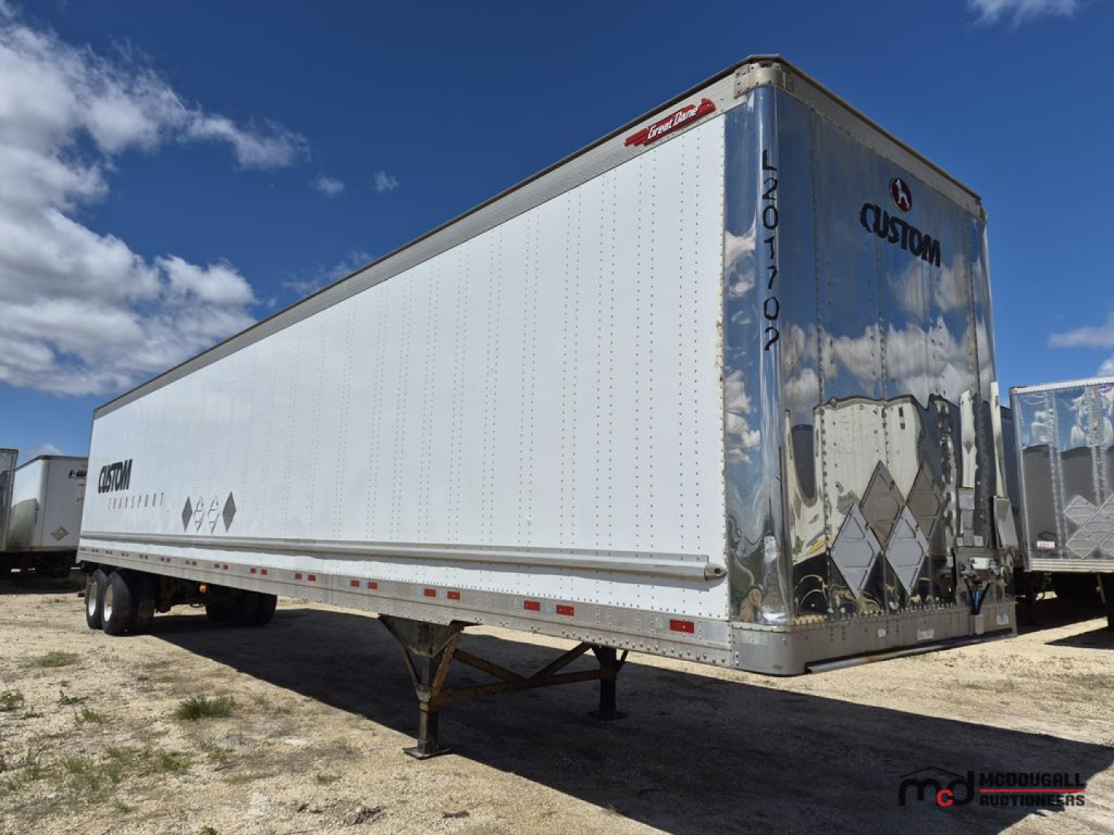 Great Dane 53' dry van semi trailer in silver/blue with Custom logo on rear doors, raised landing gear legs, and DOT/reflective tape along sides.