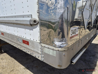 Great Dane 53' dry van trailer corner showing riveted aluminum skin and rear bumper with reflective strip and stamped serial plate.