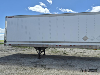 Trailer side profile showing 53' dry van trailer with tandem hitch and support legs, white exterior, DOT placards and reflective tape.