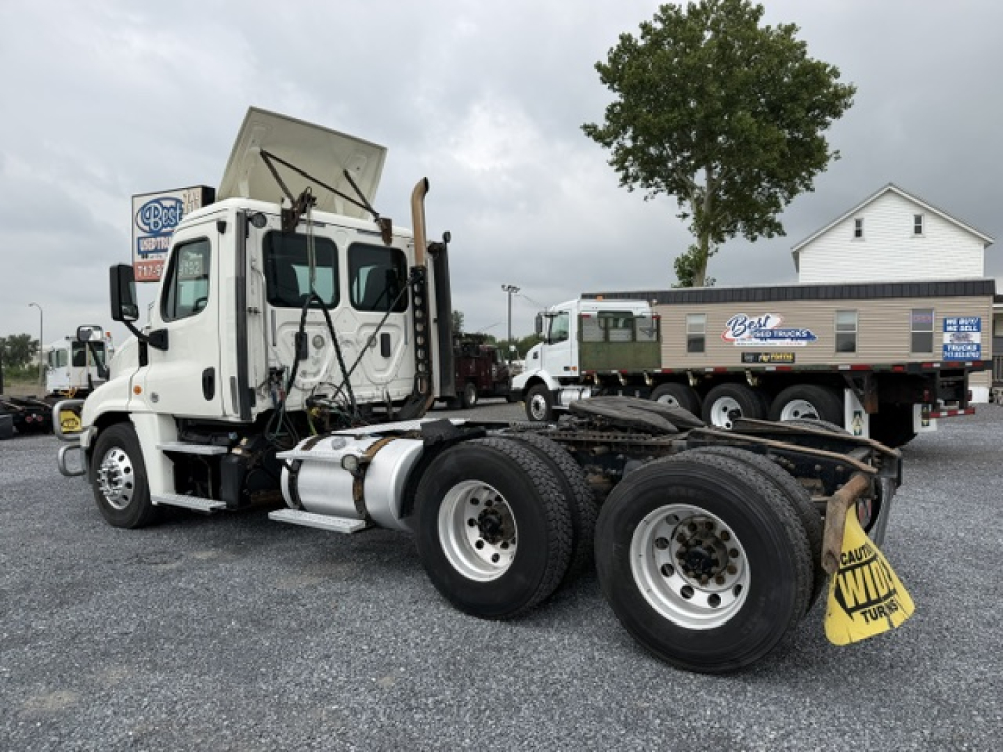 Truck chassis and cab of a 2017 Freightliner Cascadia CA125DC with exposed fifth wheel and dual rear axles, daytime lot, stock number 12925.