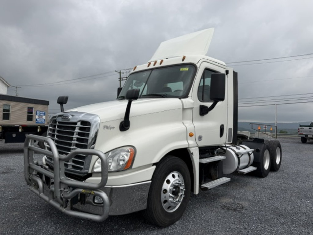 2017 Freightliner Cascadia CA125DC conventional daycab truck in white, front grille guard, dual rear axles, fuel tank, cab mirrors.