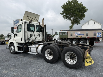 Truck chassis and cab of a 2017 Freightliner Cascadia CA125DC with exposed fifth wheel and dual rear axles, daytime lot, stock number 12925.