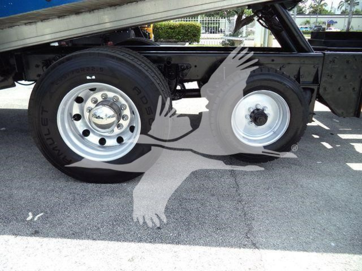Kenworth T370 rollback truck wheel area showing dual rear tires and undercarriage.