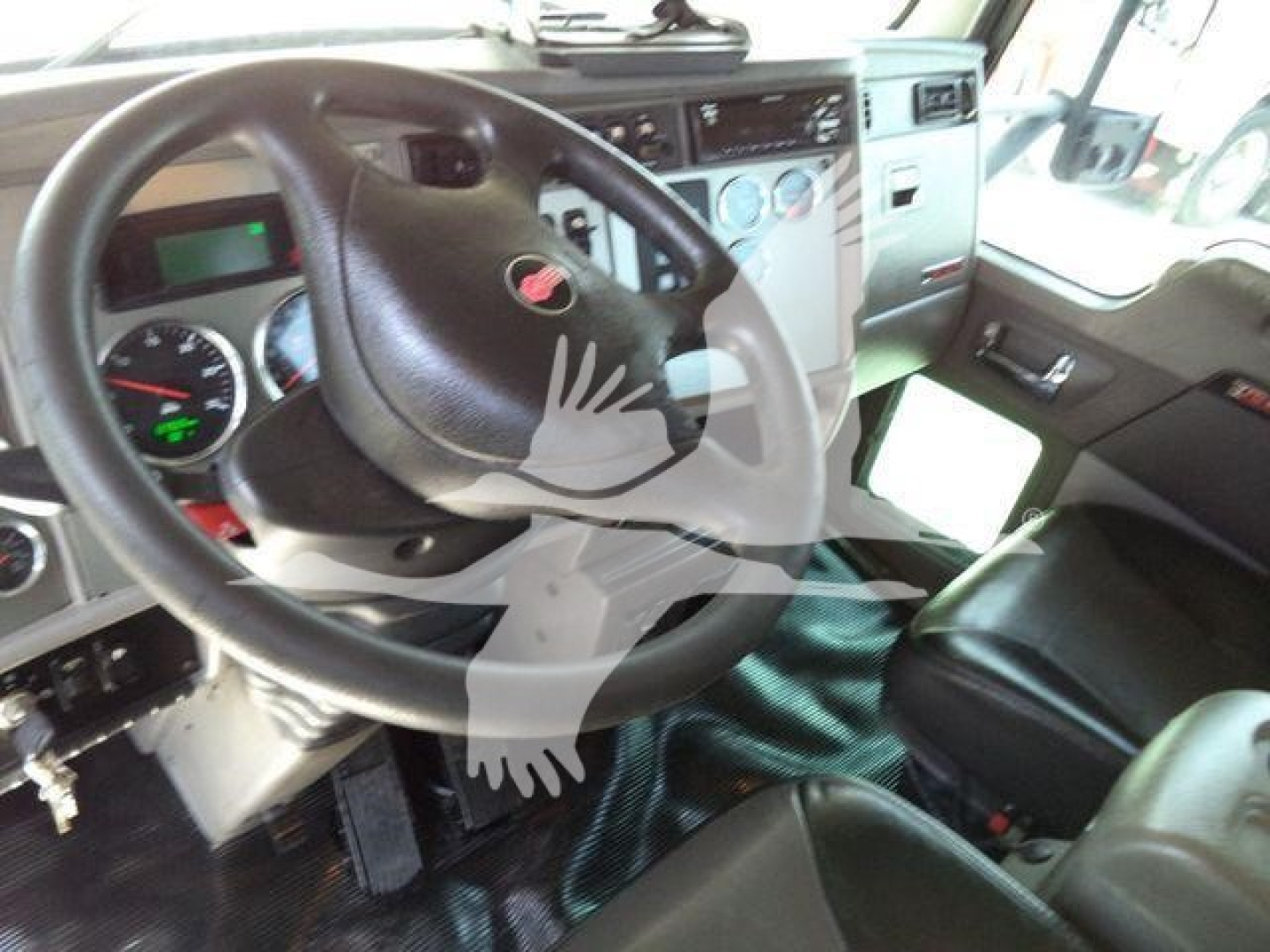 Kenworth T370 truck interior showing steering wheel, dashboard gauges, and driver seat.