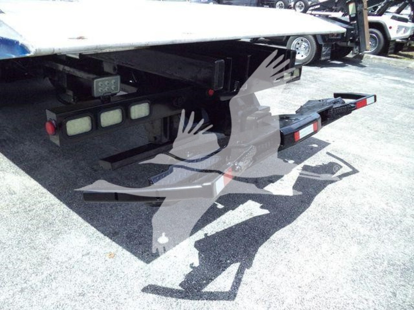 Kenworth T370 rollback truck rear view showing hitch platform and taillights.
