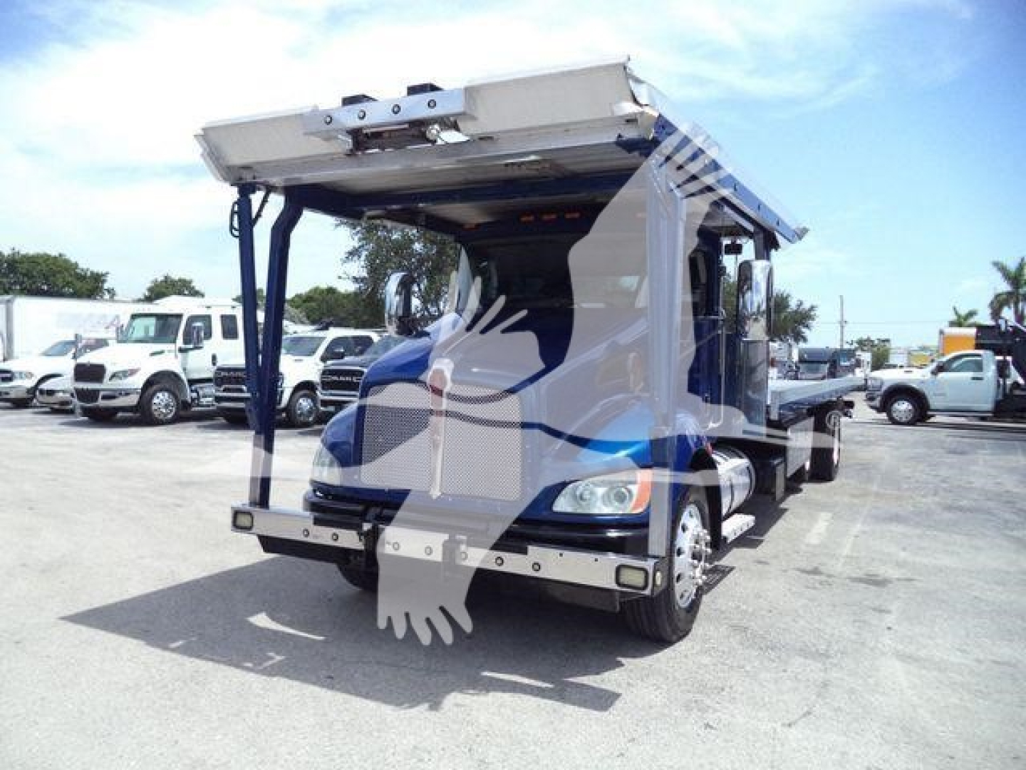 2016 Kenworth T370 rollback truck rear view showing hydraulic bed and rear bumper.