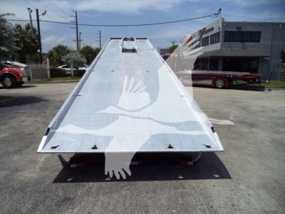 Kenworth T370 rollback tow truck flatbed viewed from rear, with hydraulic ramp extended and tail lights visible.