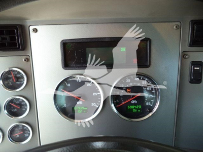 Kenworth T370 dash panel showing multiple gauges; odometer and digital readouts visible behind steering wheel.