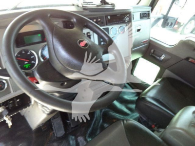 Kenworth T370 truck interior showing steering wheel, dashboard gauges, and driver seat.