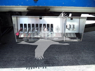 Kenworth T370 rollback truck rear panel showing electrical / control panel with fuses and connectors.
