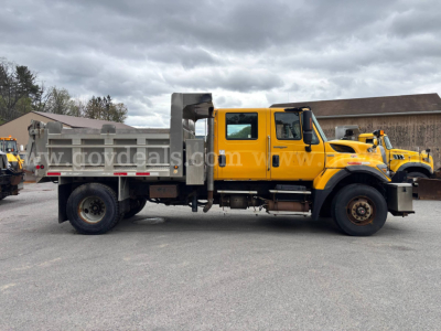 Dump truck: yellow Sterling L8500 cab with gray dump bed, side view showing wheel, door, and tool compartment. Text on image appears as watermark