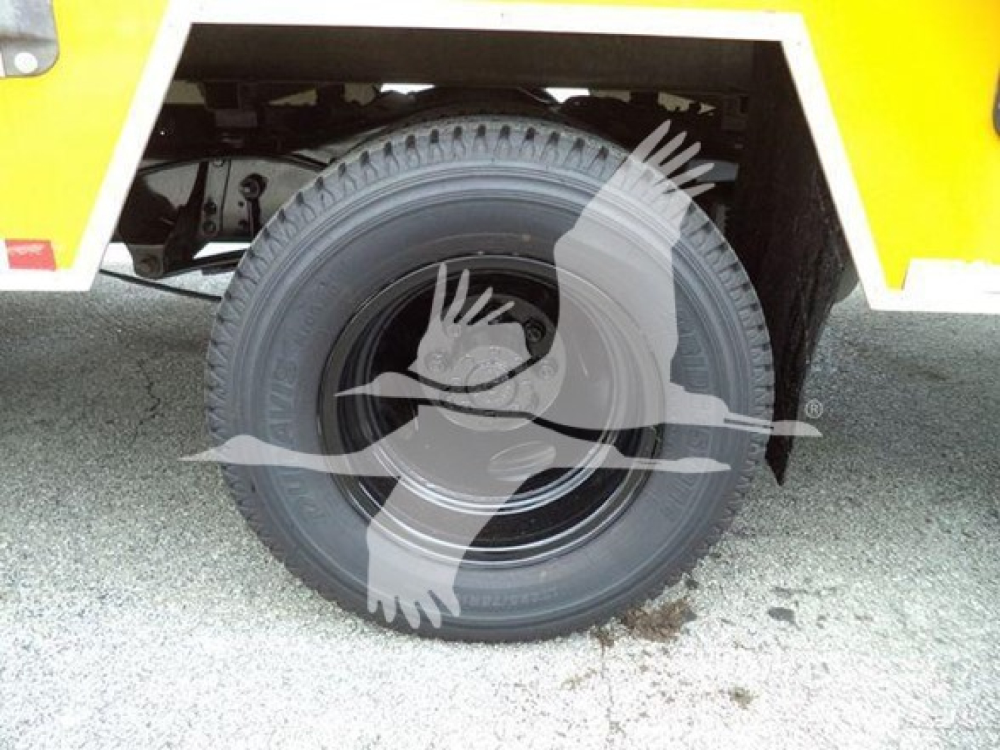Truck wheel and tire showing the rear wheel well of a 2022 Ford E350 XL SD cutaway.
