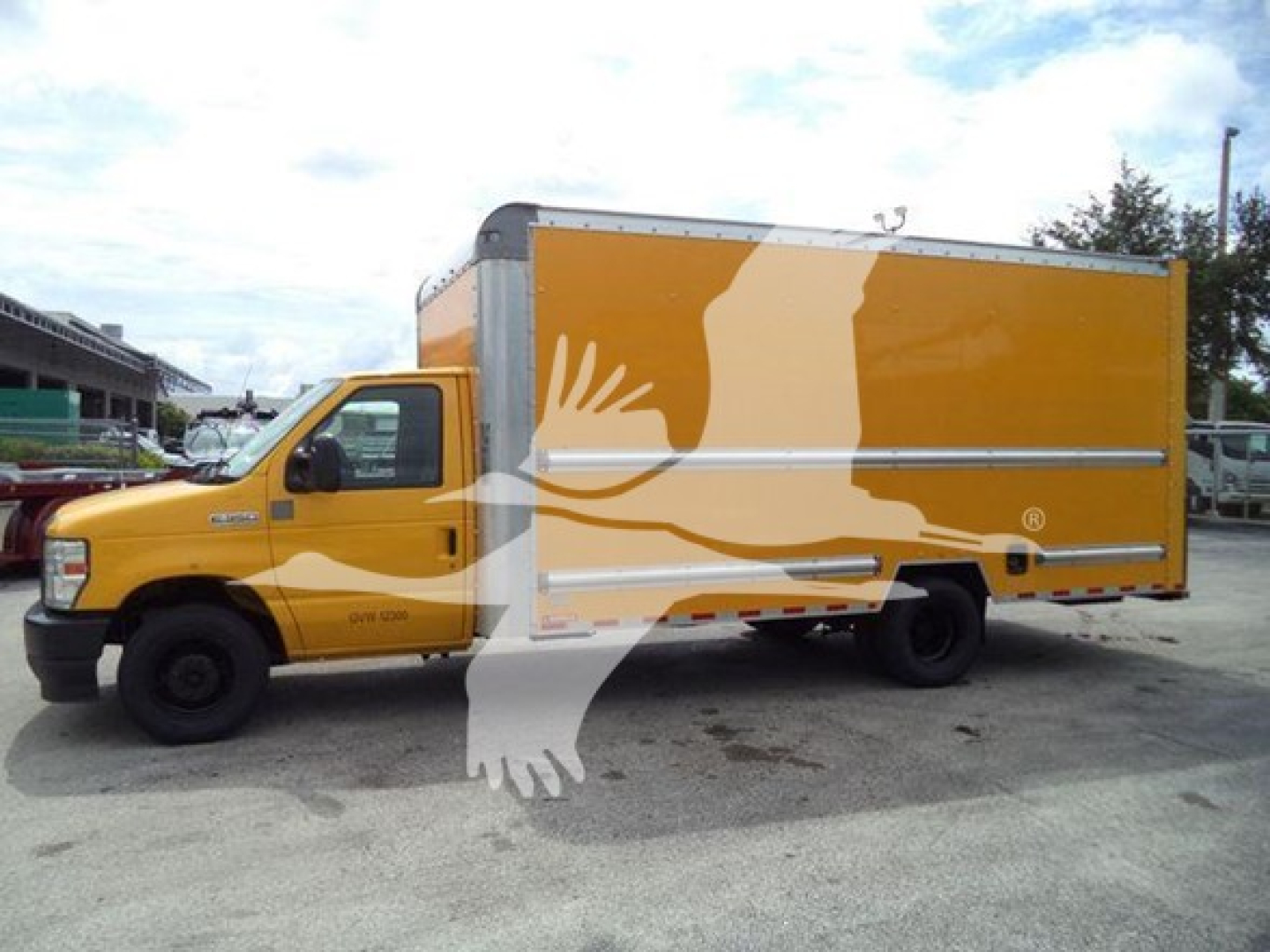 Ford E-350 box truck side view showing yellow cargo box and cab with stock number T04043 and VIN 1FDWE3FN1NDC04043