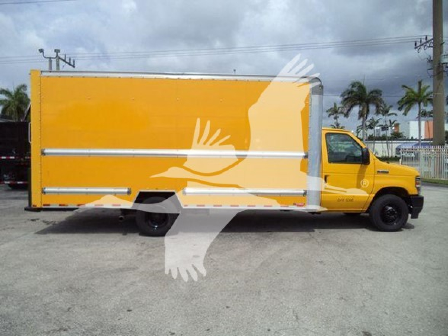 Ford E-350 cargo box truck side profile showing yellow box body and cab with stock number T04043.