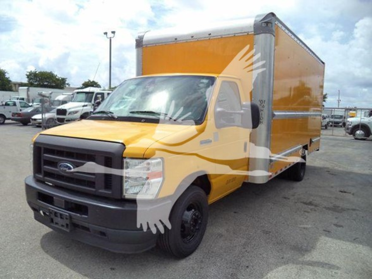 Ford E-350 cargo box in yellow and gray cab front view with black bumper and wheel, daylight; no visible model stickers.