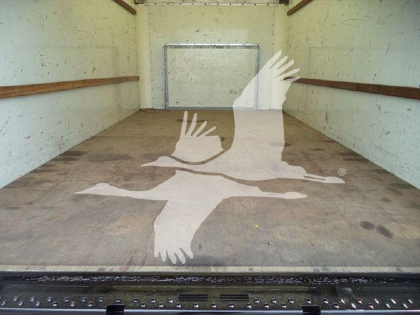 Interior cargo area of a 2022 Ford E350 XL SD truck with empty box; watermark of birds logo overlaying the floor.
